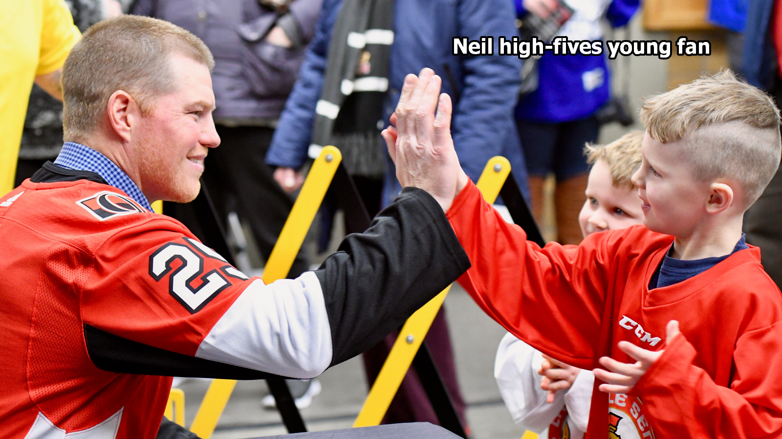 Neil high-fives young fan