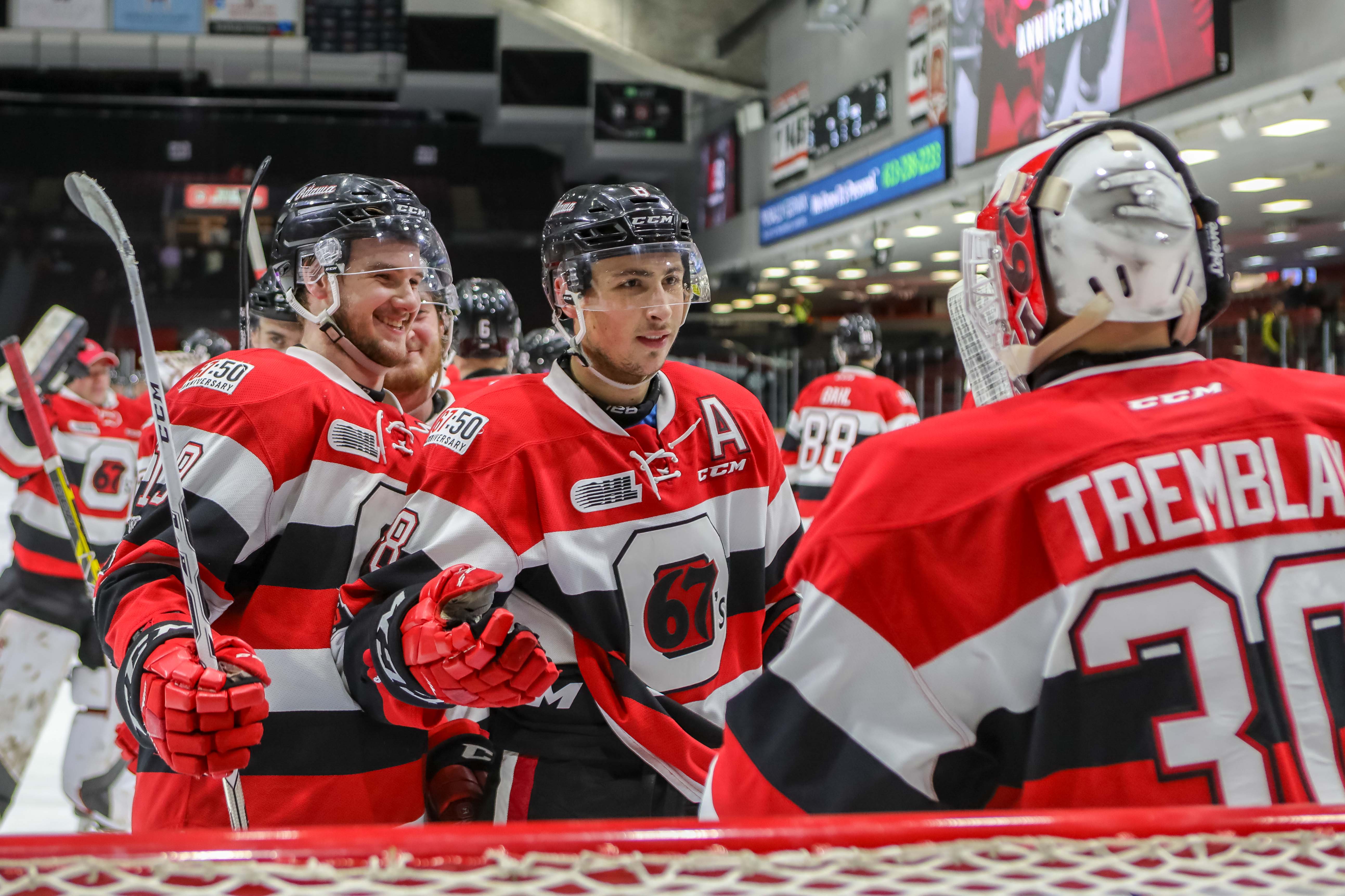 Barron, Chmelevski, and Tremblay celebrate after defeating Mississauga.