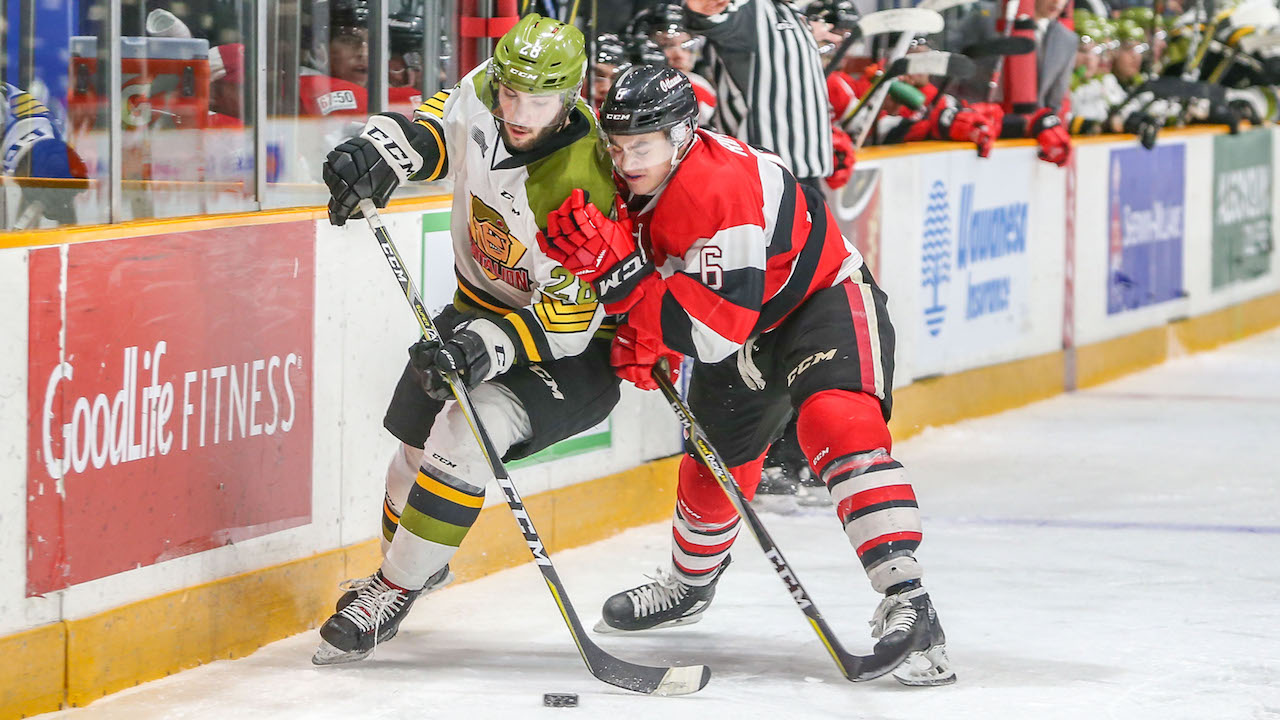 Rippon battles Battalion forward for puck.
