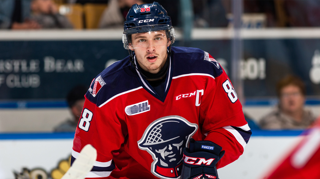 Greg Meireles wearing the Rangers alternate red jerseys in a game versus the Guelph Storm