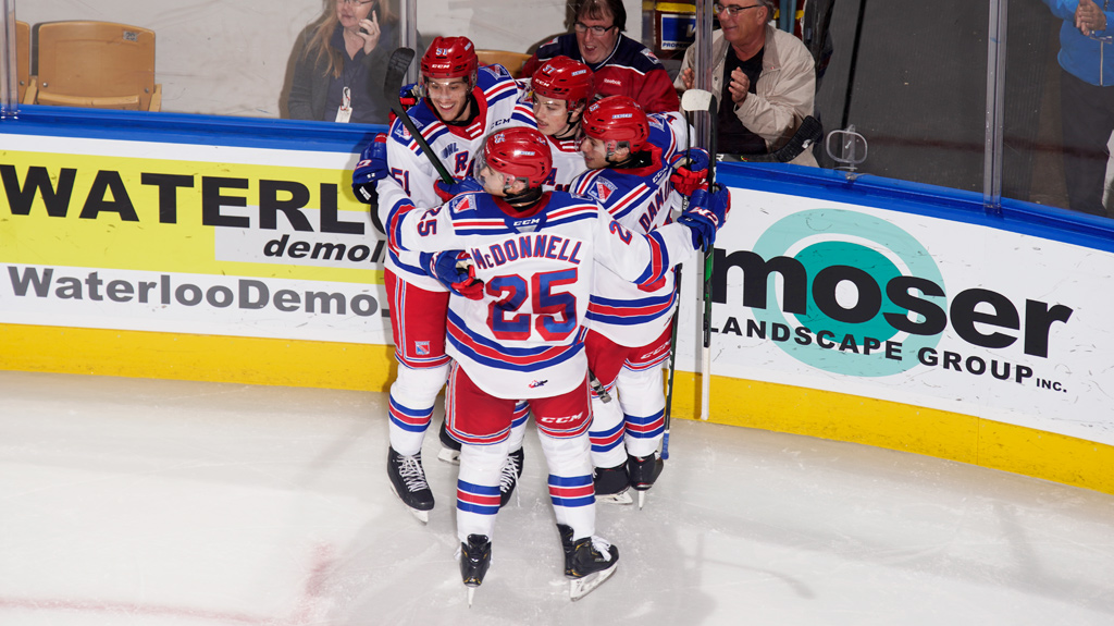 Kitchener Rangers hugging after a goal