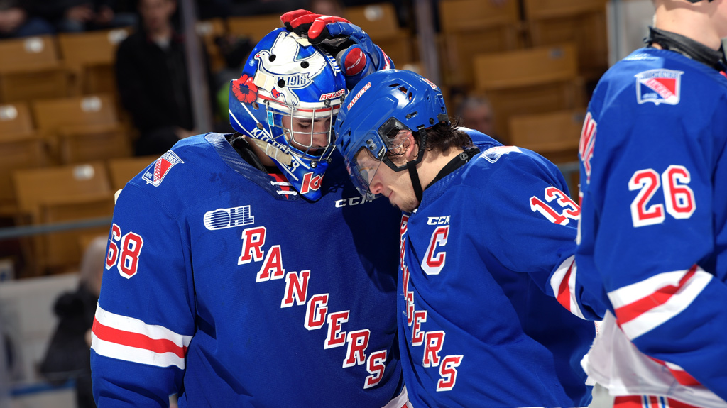 Jacob Ingham and Riley Damiani butting helmets for the Rangers