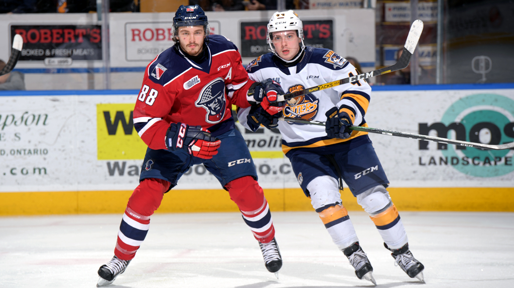 Greg Meireles battles for position with an Erie Otters player
