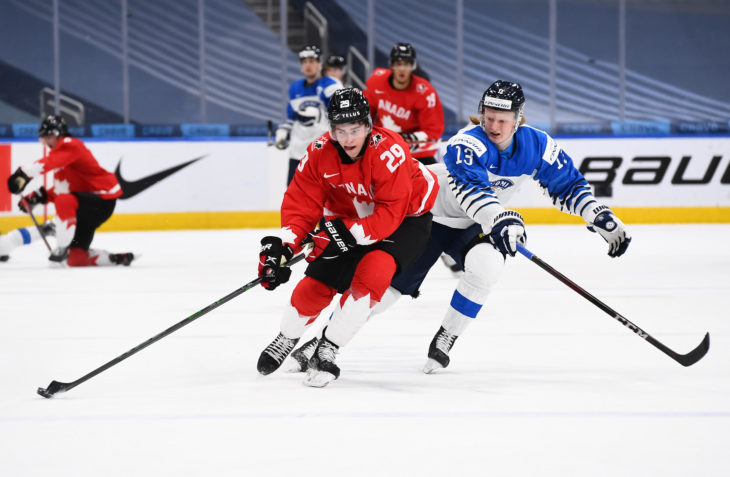 EDMONTON, AB CANADA - DECEMBER 31: Canada's Jack Quinn #29 skates with the puck while Finland's Roby Jarventie #13 chases him down during preliminary round action at the 2021 IIHF World Junior Championship at Rogers Place on December 31, 2020 in Edmonton, AB Canada. (Photo by Andrea Cardin/HHOF-IIHF Images)
